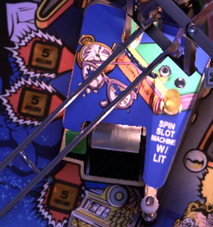 The yellow 5 MILLION Greed Targets clustered beside the Slot Machine on the installed Twilight Zone playfield
