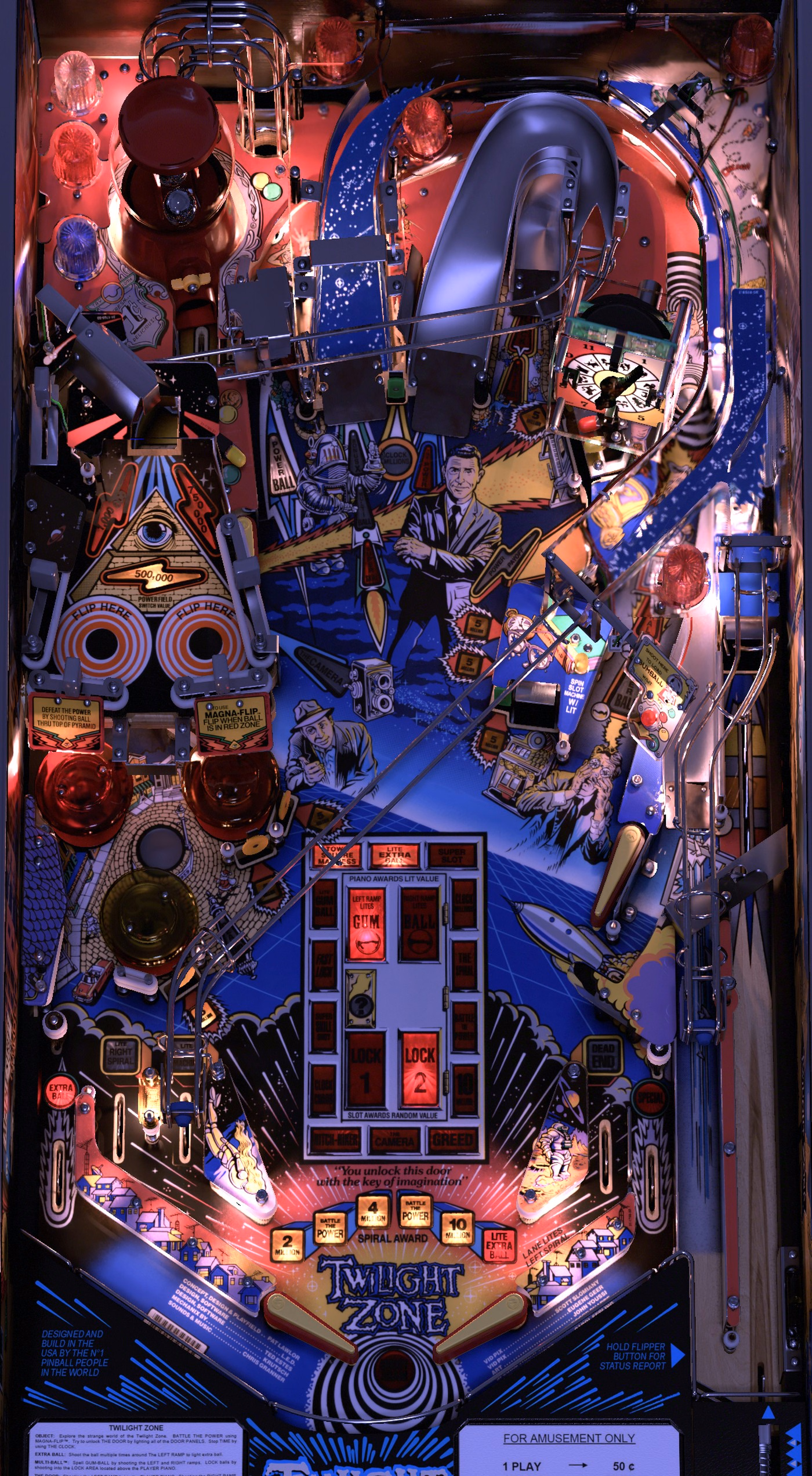 The installed Twilight Zone playfield from above: the red Gumball Machine dome top left, the pyramid Powerfield and the jet bumpers down the left side, the clock and the Player Piano in the upper middle, the Slot Machine and the Lock Lane on the right, the Door in the lower middle and the plunger lane along the right edge